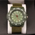 Close-up of military green watch with nylon canvas strap and numeric bezel detail - Army Green