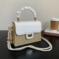 Handcrafted straw woven box bag featuring white leather flap and unique ruffled top handle - White