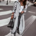 Detailed view of a light grey long trench coat for women with large lapels and button front. - S / Tops / Light Gray