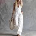Stijlvolle witte linnen mouwloze jumpsuit met V-hals en knopen aan de voorzijde - XS / Dresses / Wit