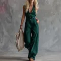 Donkergroene mouwloze linnen jumpsuit met V-hals en knopen in westerse chique stijl - Groen