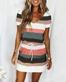 Close-up detail of women's short sleeve striped dress with drawstring waist and pockets. - Dark Green