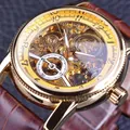 Detailed close-up showing the golden gear movement of a Forsining men's skeleton watch - Gold Case Gold Dial