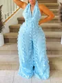 Detailed view of light blue halter neck wide leg jumpsuit with textured tassel fabric. - S / Jumpsuits / Blue
