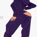 Close-up of purple fuzzy hooded onesie pajamas featuring a functional back flap - Dark Purple