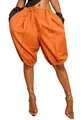 Waist-down view of vibrant orange pleated lantern shorts with unique elastic hem design - S / Bottoms / Orange