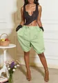 Full body view of trendy light green baggy lantern shorts on a female model in a stylish room. - S / Bottoms / Green