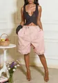 High-waisted light pink balloon shorts for women styled with a black top in a studio - S / Bottoms / Pink