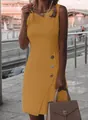Detail showing the side decorative buttons of an elegant mustard yellow sleeveless dress - S / Dresses / Yellow