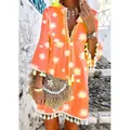 Detail of bright orange daisy print bohemian dress with V-neckline and tassel fringe hem - S / Dresses / Orange