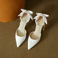 Elegant white pointed-toe stiletto heels featuring a satin bow and pearl ankle strap - 31 / 5cm Heel / White