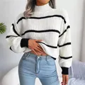 Detail shot of the knit texture on this striped mock neck sweater with lantern sleeves - One Size / Tops / White