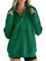 Close-up of green oversized half-zip sweatshirt with fleece lining and front pocket. - Green