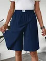 Detail view of navy blue casual skort showing the overlapping skirt panel and pockets. - S / Bottoms / Dark Blue