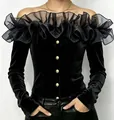 Elegant black velvet off-the-shoulder blouse featuring sheer ruffle collar and gold buttons - Black