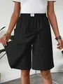 Detail view of women's black casual skort showing the split skirt-front design - S / Bottoms / Black