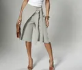 Close-up detail view of elegant wrap-around tie-waist wide-leg culottes in soft sage green - Light Gray