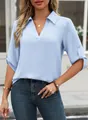 Detailed view of light blue V-neck shirt with textured fabric and rolled sleeves - S / Sky Blue