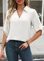 Detailed view of white V-neck shirt with rolled-up sleeves and textured fabric - S / White