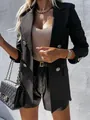Close-up detail of a stylish black double-breasted blazer with vintage gold buttons - S / Tops / Black