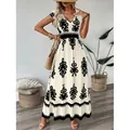 Robe longue bohème crème avec imprimé floral noir et taille haute ajustée. - Abricot