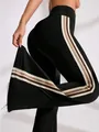 High-waisted black flared yoga pants featuring stylish side stripes and elastic sport fit - S / Bottoms / Black