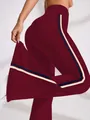 High-waisted flared burgundy yoga pants with side stripes and quick-dry elastic fabric. - Burgundy