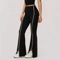 High waisted black flared yoga pants with white side stripes and split hem detail - S / Bottoms / Black