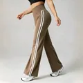 High-waisted athletic brown yoga flare pants featuring sporty white side stripes - S / Bottoms / Khaki