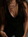 Detailed close-up shot of a chic black velvet vest with buttons and gold jewelry. - S / Tops / Black