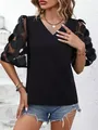 Detail view of women's black V-neck top featuring 3D mesh polka dot puff sleeves - S / Tops / Black