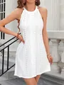Close-up detail of the intricate floral eyelet embroidery on this white halter dress - S / Dresses / White