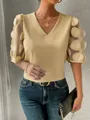 Detail view of a yellow sheer bubble sleeve blouse with 3D dot appliques and V-neck - S / Tops / Yellow