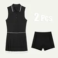 Ensemble de tennis 2 pièces noir avec col polo sans manches et jupe plissée. - XS / Ensemble / Noir