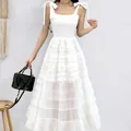 Elegant white sleeveless mesh tiered long dress featuring bow tie shoulder straps - S / Dresses / White