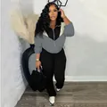 Stylish women's two-piece tracksuit featuring color-blocked zip-up jacket and black leggings. - Gray