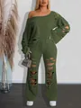 Detailed view of women's distressed two-piece set with off-shoulder sweatshirt and ripped pants - Green