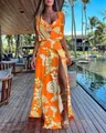 Detailed view of vibrant orange floral two-piece set with high slit skirt at a resort - S / Top And Bottom / Orange Gold Floral