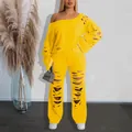 Vibrant yellow off-shoulder ripped sweatshirt and matching distressed pants set - Yellow