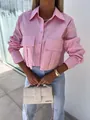 Detailed view of women's loose pink long-sleeve blouse with batwing sleeves and pockets - S / Tops / Pink
