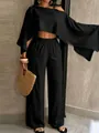 Dettaglio completo nero con top monospalla e pantaloni larghi in tessuto crinkled - Taglia S / Top E Pantaloni / Nero