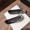 Elegant black ballet flats featuring shimmering rhinestone toes and delicate bows for women. - 35 / Black