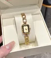 Detailed view of a vintage minimalist gold quartz watch for women with chain strap - Gold