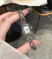 Detailed view of a silver retro quartz watch with a unique link chain strap design. - Silver
