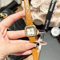 Close-up detail of a fashion Dinimi square wristwatch with a brown quilted leather strap - Khaki
