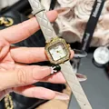 Elegant women's square watch with crystal bezel and quilted grey leather strap detail. - Gray