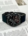 Close-up detail of GUOU black chronograph watch with silicone strap on a magazine - Black Strap Black Gun Frame (Silicone)