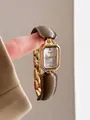 Detailopname van een vintage goudkleurig horloge met een bruine leren horlogeband - Rechthoekige Gouden Wijzerplaat Leren Ketting Splits Stijl / Brons