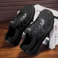 Detailed macro view of black wide-toe men's hiking shoes with breathable mesh panels - 39 / Black