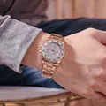 Rose gold luxury men's watch with steel strap and calendar on model wrist - Rose Gold Steel Grey
